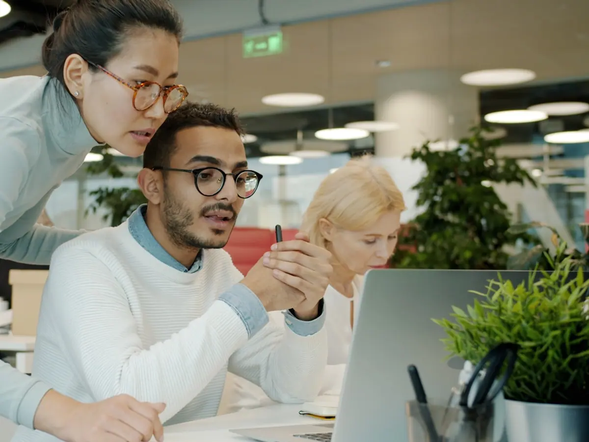 Two colleagues reviewing a workflow on screen